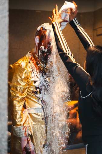 Heaven — flour poured over the coated figure in gold.