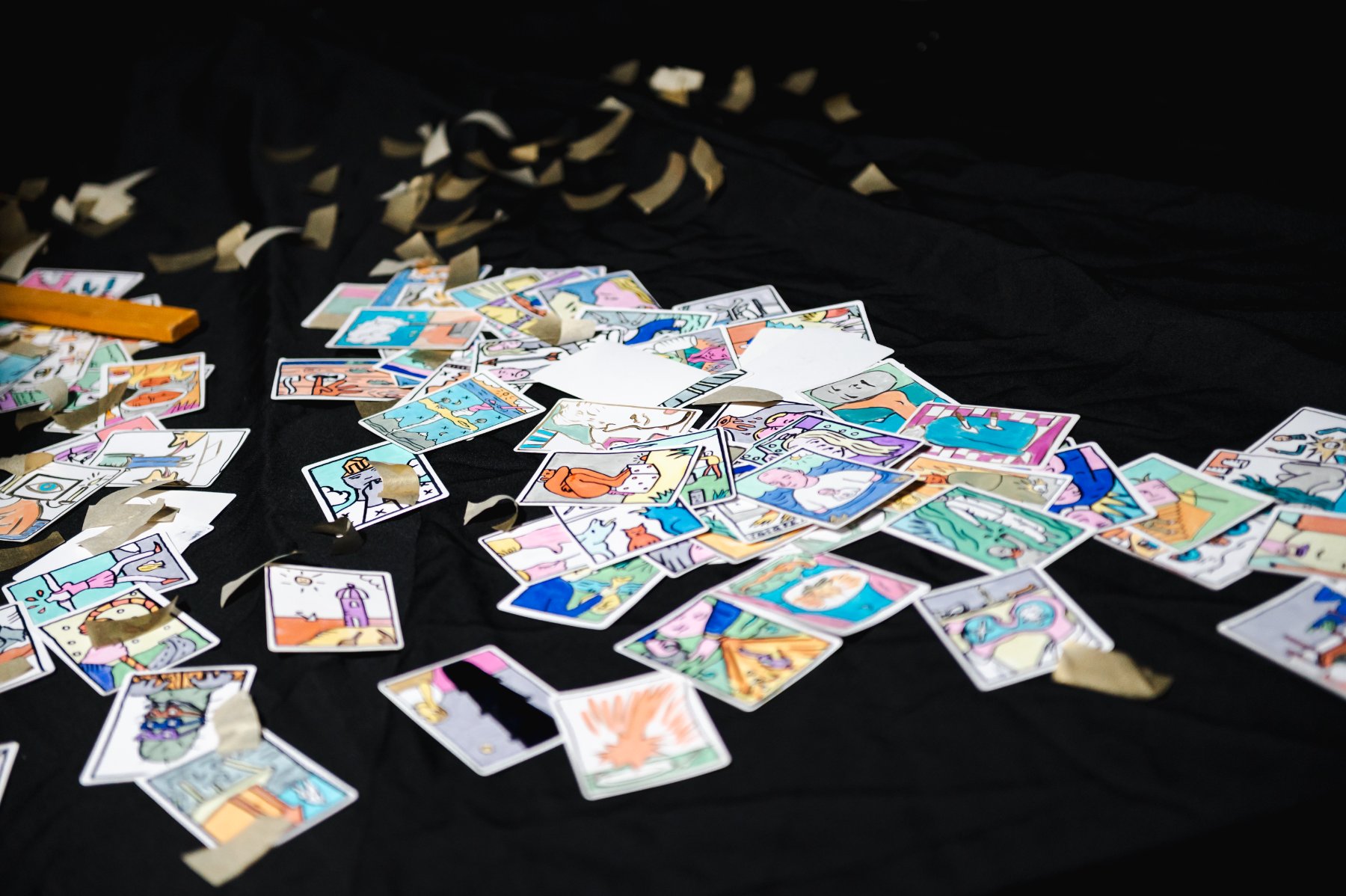 Purgatory — hand-drawn cards scattered across a black cloth with confetti.